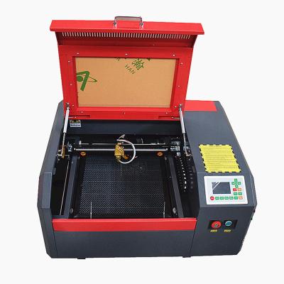 China Ruida 50w 4040 Controller Water Cooled CO2 Laser Engraving Machine for sale