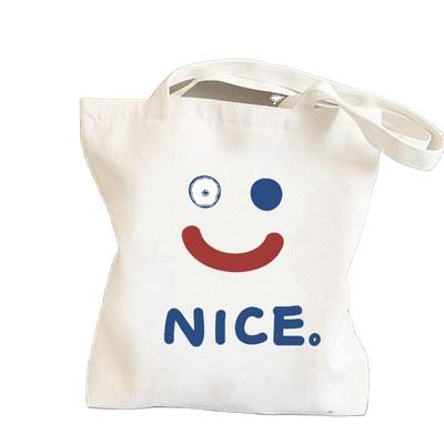 China Folding smile face printed side bags for girls shoulder women handbag for college students Tote Canvas Bags for sale