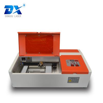 China Laser Engraving Mini Laser Engraving Machine For Perfume Bottle Carving Dongxu Laser Machine 300x200mm 40w for sale