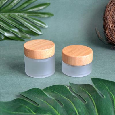 China Korean Wholesale Personal Care Body Lotion Round 15 30 50 100ml Frosted Glass With Bamboo Lid Cosmetic Jar for sale