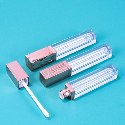 China Cosmetic empty lip gloss tube 6.5ml clear lip gloss bottle lip tube square lip gloss bottle rose long gold band lip gloss liquid tube packaging for sale