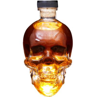 China Beverage Custom special skull shape 750ml glass spirit bottle whisky liquor bottle with wooden cork for sale