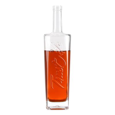 China Beverage Custom embossed logo 700ml 750ml spirit glass liquor bottle long neck round vodka whisky rum gin glass bottle with bartop for sale