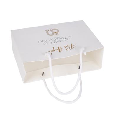 China Recyclable Luxury Store Logo Printed Custom Paper Bags for Clothing Packaging for sale