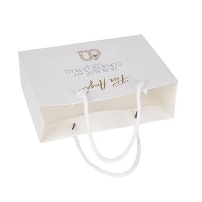 China Recyclable Luxury Personal Store Logo Printed Custom Paper Bags for Clothing Packaging for sale