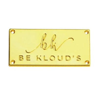 China Viable Wholesale Made Gold Clothing Label Logos Zinc Alloy Garment Nameplate Sewing Labels For Swimwear for sale