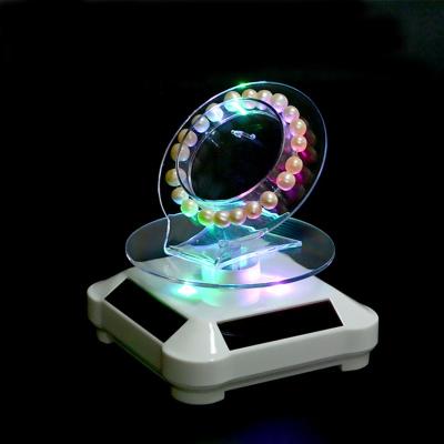 China ABS / Acrylic Solar Powered Rotating Special Rotating Display Stand Bracelet Jewelry Display Stand for sale