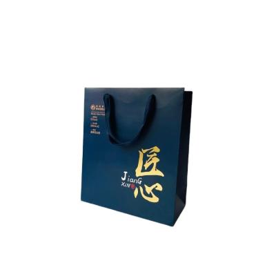 China Recyclable Custom Printed Personalized Blue Glossy Laminated Retail Shopping Paper Bag With Logos for sale