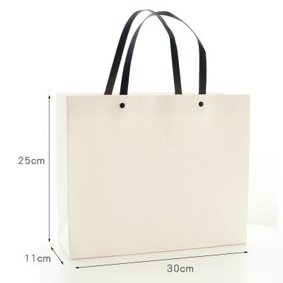 China Recyclable simple pure color rivet gift bag wedding clothing bag and merry Christmas gift bag paper bag bag with hand for sale