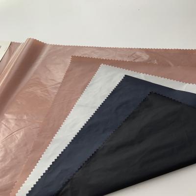 China Bright Waterproof Fabric 100%nylon PU Taffeta Lining Fabric For Fashion Wear for sale