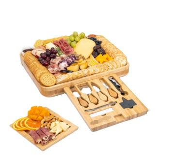 China Disposable deluxe bamboo cheese board pack with all accessories and drawers and knife and ceramic bowls for sale