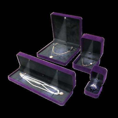 China Luxury Purple Velvet Jewelry Display Box Custom Logo Jewelry Packaging Boxes Led Light Jewelry Box for sale