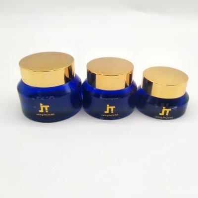 China 50ml daily life cream blue round glass jar with custom color screw cap for cosmetic packaging ready to ship for sale