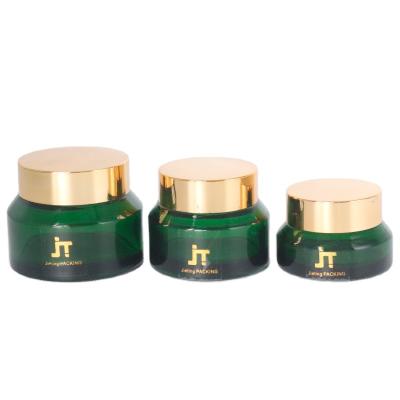 China Hot Sales Cosmetic Custom Cosmetic Cream Jar Green Glass Cosmetic Packaging With UV Lid for sale