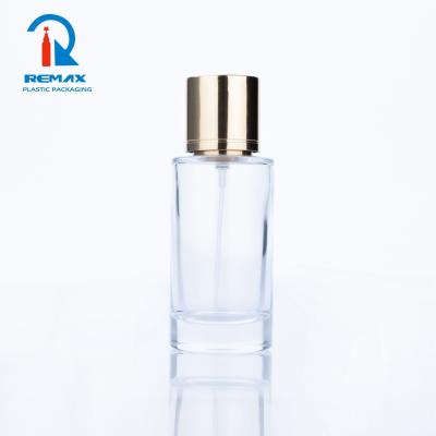 China Non Spill 2021 Hot Selling 50ml Clear Glass Perfume Bottle Empty Glass Round Perfume Bottle With Gold Etched Magnetic Spray Cap for sale