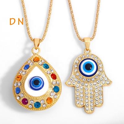 China Dina Hand Charm Necklace Turkey Blue Evil Eyes Wholesale European Alloy Fatima Hamsa Vintage Diamond Jewelry Sweater Necklace Jewelry for sale