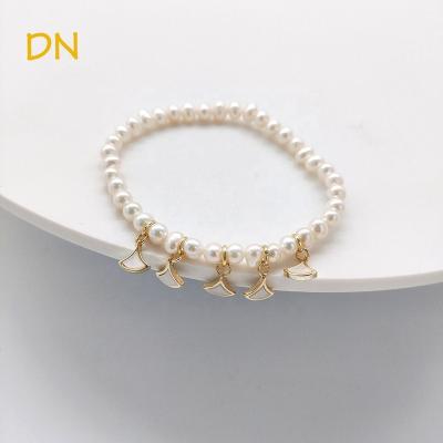 China Dina Wholesale France Romantic Brass Triangle Charms Bracelet 4mm Natural Freshwater Pearl Beaded Bracelet Jewelry For Women for sale