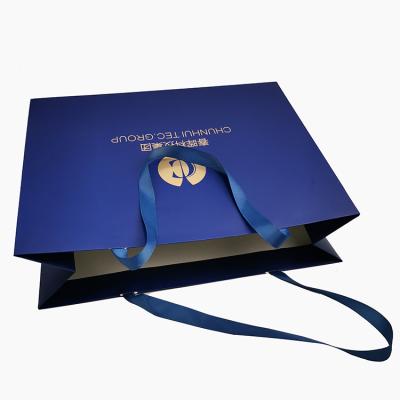 China Customized Recyclable Hot Sale Printing Logo Luxury Blue Packaging Paper Bags With Handle for sale