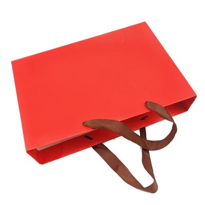 China Hot Sale Recyclable Customized Designer Red Paper Delivery Bags With Ribbon Handle for sale