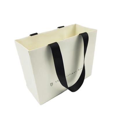 China Handmade Art Design Paper Free Custom Biodegradable Paper Bags For Clothes With Handle for sale