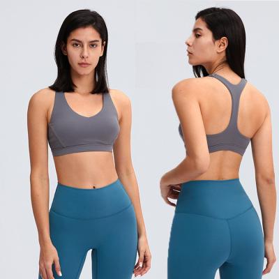 China 2021 Beautiful Solid Color Double Layers Sexy Triangle Underware Breathable Nylon Yoga Stitching Back Shockproof Fitness Sports Bra for sale