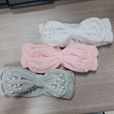 China Soft Solid Pearl Embellished Winter Soft Warm Hairband Sweet Knot Elastic Hairband Beautiful For Women And Girls for sale