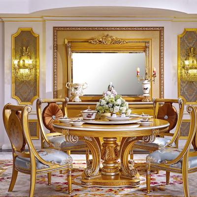 China Royal dining room furniture set classic European antique luxury chair solid wood gold leaf plated hand carved round dining table for sale