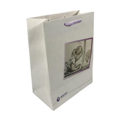 China Wholesale Biodegradable 2022 New Hot White Matt Laminated Rope Handle Printed Flower Customer Paper Bag for sale