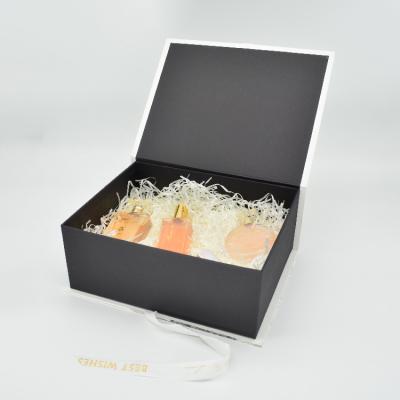 China Handmade Perfume Clothing Customization Black Hardcover Book Form Embossed Gold Foil Gift Box With Ribbon for sale