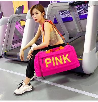 China Large Capacity Letter Logo Sports Gym Duffel Travel Multifunctional Gold Printing Pink Bag With Shoes Compartment Pocket Hand Sling Strap Protection for sale