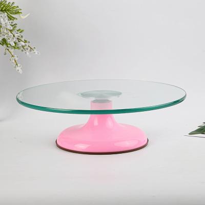 China Viable Pink Base Non-slip Round Cookie Decorating Stand Tempered Glass Cake Rotating Turntable for sale