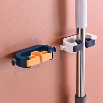 China Hot Selling Broom Holder Bathroom Broom Hanger Self Adhesive Wall Mounted Broom Hook Non-Slip Amazon Broom Holder for sale