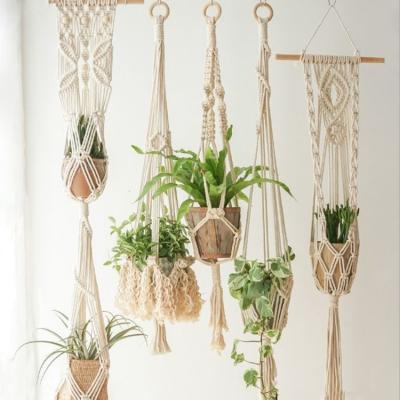 China Eco-friendly macrame plant hanger set plant pot hangers macrame plant hanger shelf boho home decorations for sale