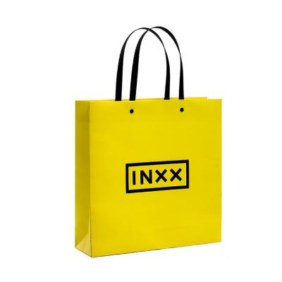 China Recyclable Wholesale Luxury Yellow Shoes Clothes Kraft Paper Bags Printed Custom Logo for sale