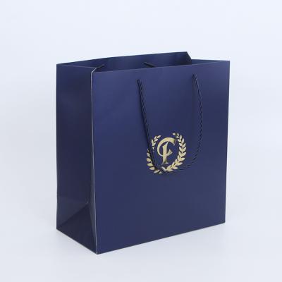 China Recyclable Custom Shiny Gold Stamping Navy Blue Shoes Paper Shopping Bag For Clothing Package for sale