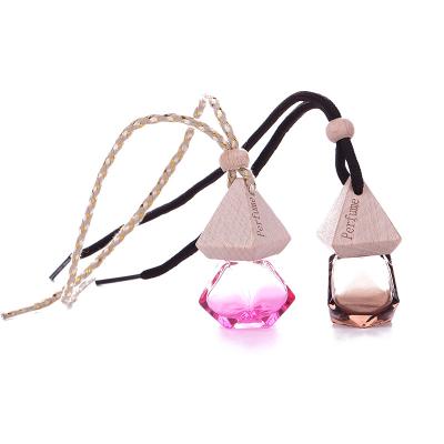 China Personal Care in 6ml Stock Wooden Cap Metal Clip Shape Hanging Creativity Car Perfume Diffuser Glass Bottle for sale