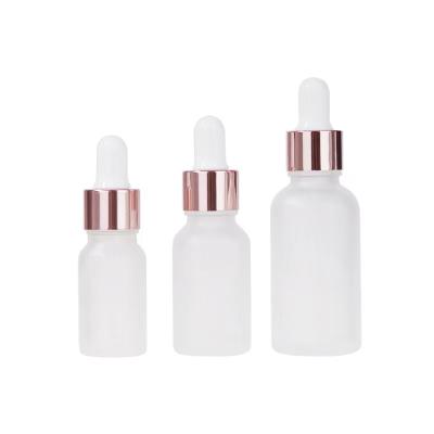 China Clear 5ml 10ml 15ml 20ml 30ml 50ml 100ml Essential Oil Cosmetic Wholesale Frosted Glass Bottle With Rose Gold Lid for sale