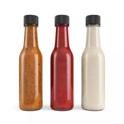 China Food 150ml 5oz Clear Sauce Glass Bottle For Hot Sauce Glass Bottle With Plastic Black Lid for sale