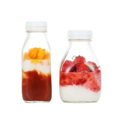 China Wholesale Square 300ML 500ML 1000ML Empty Milk Fruit Beverage White Tamper Proof Juice Drink Glass Bottles With Cap for sale