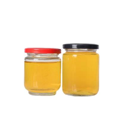 China Luxury Empty Clear 280ml Food Round Shape Honey Jar With Screw Gold Metal Glass Lid for sale