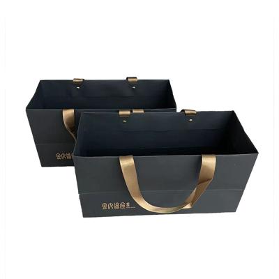 China Recyclable Recyclable Valve Packaging Twisted Floral Black Iridescent Punch Hole To Handle Metallic Gold Foil Embossed Paper Bag for sale