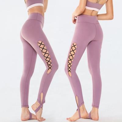 China Hot Sale Breathable Stirrup Crisscross Hollow Workout Yoga Pants 2020 Womens Leggings Yoga Fitness Wear Women Sports Clothing Manufacturer for sale