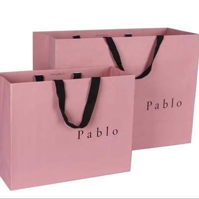 China Cheap Garment Recyclable Hot Sales Kraft Paper Printed Gift Packaging Boutique Paper Bag With Ribbon for sale