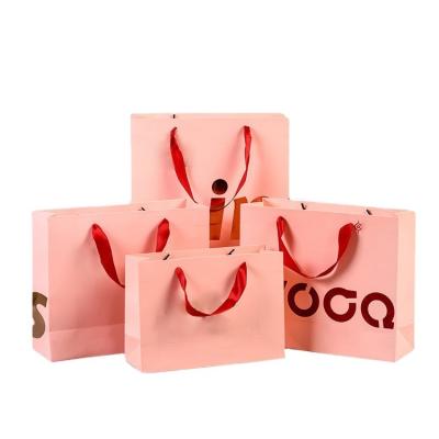 China Custom Recyclable Biodegradable Packaging Pink Logo Printed Paper Shopping Bag With Ribbon Handle Paper Bag for sale