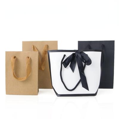 China Recyclable Luxury Gift Shopping Bags With Logos Black Kraft Paper Bag With Handle Retail Paper Shopping Tote Bags For Clothes for sale