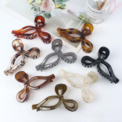 China Hair claw Bow Ribbon Shaped Black White Large Matte Hair Claw Clips Wholesales Ponytail Jaw Claw Clip Non Slip Hair Clips for Women Claw for sale