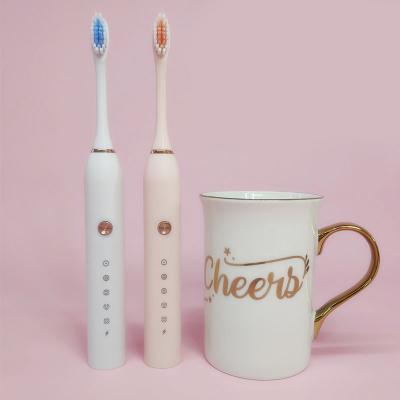 China New Product Battery Operated Children's Oral Care Set Free Sample Three Sided Low Intensity Electric Toothbrush With Charging Station for sale