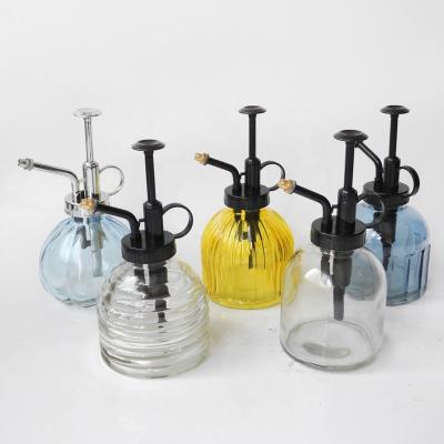 China Clear Glass Water Garden Pump Bottle With Black Copper Sliver Pump Lid for sale