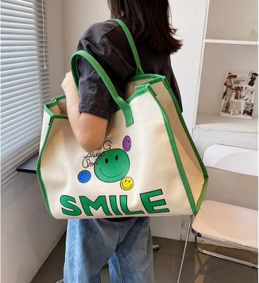 China Fashion 2021 Spring And Summer New Bag Smile Face Cartoon Printed Student Canvas Bag Tote Messenger Bag for sale