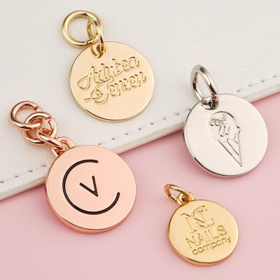 China ISO Certified Golden Round Metal Tag For Handbags Custom Engraved Logo Bag Accessories for sale